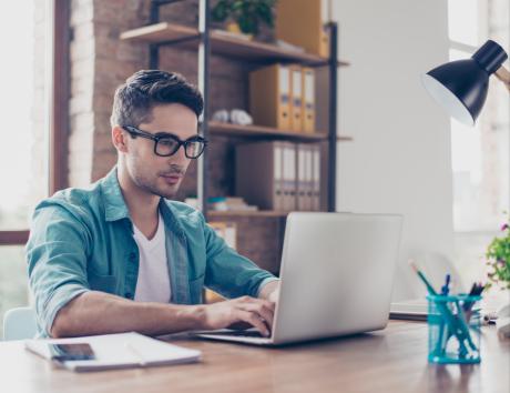 Homme travaillant sur son ordinateur portable pour rédiger un CV fonctionnel